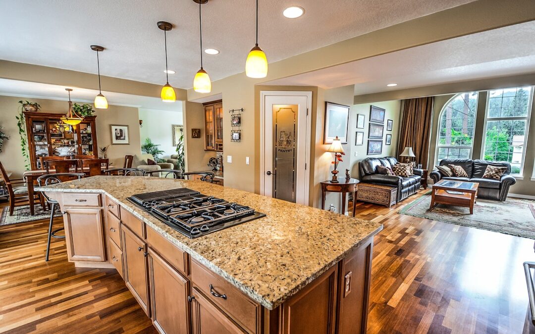 Photo of interior of open floorplan home with warm wood floors, granite counter kitchen, formal dining room and living room