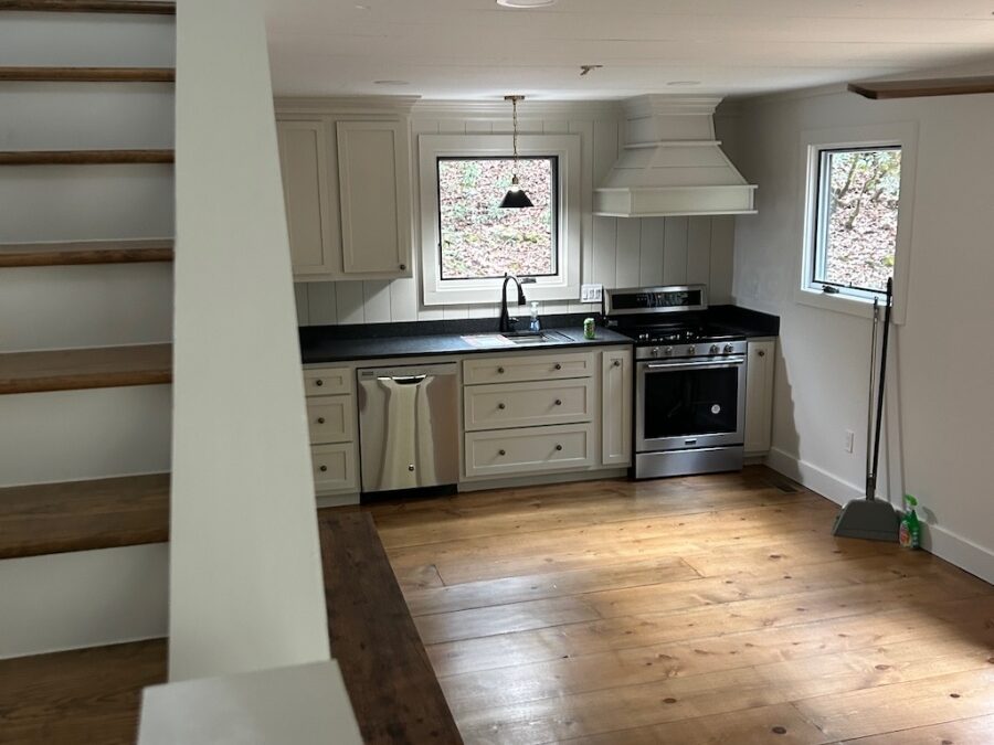 Photo of kitchen and stairwell in "tall skinny' three story log home